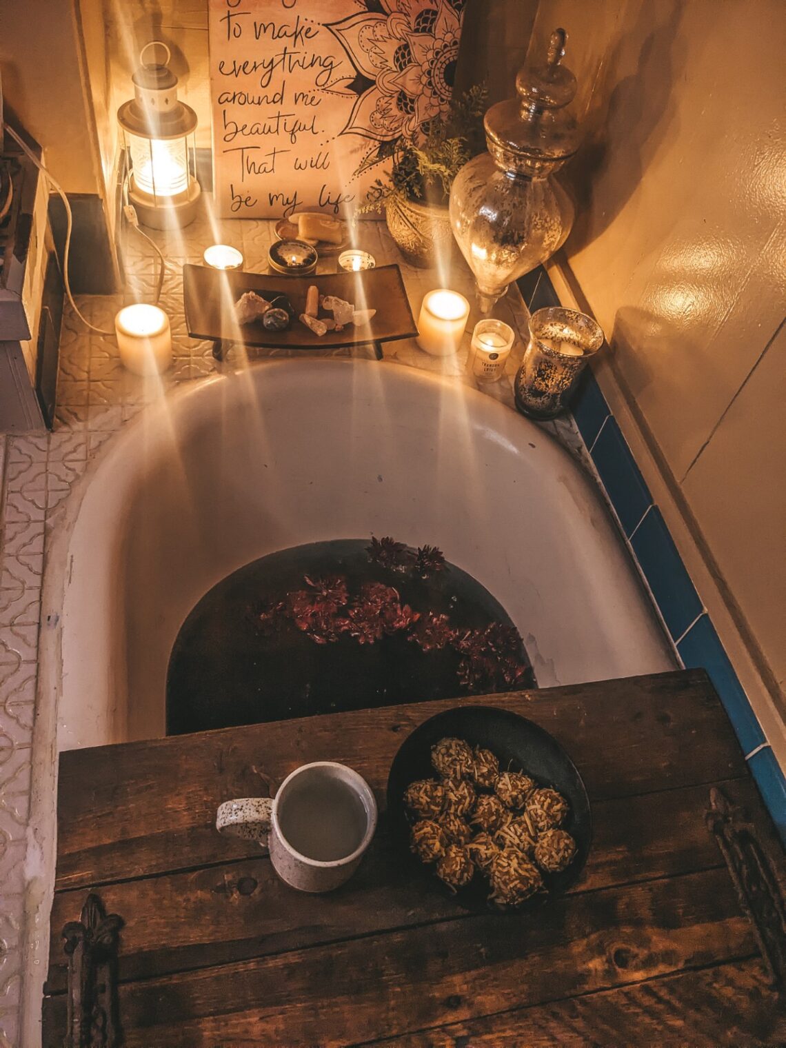 New Moon Ritual Bath with candles, crystals, ayurvedic sweets, hot tea, and midnight dahlias.