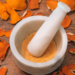 Natural Vitamin C exfoliant in a white marble mortar surrounded by orange peel